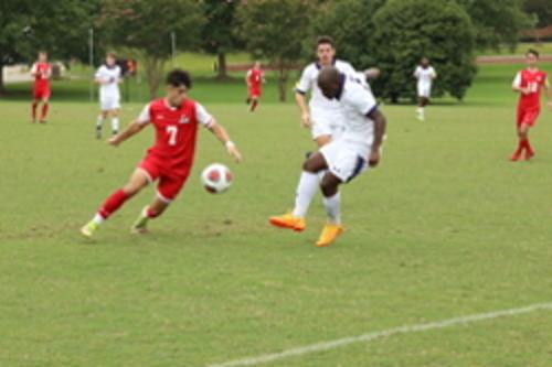 Students playing on soccer field